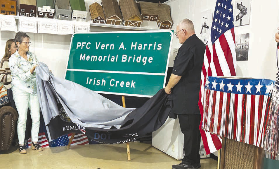The Fallen Heroes Memorial Bridge sign is unveiled by Mary Harris and Jim Harris at Isabel on Sunday.