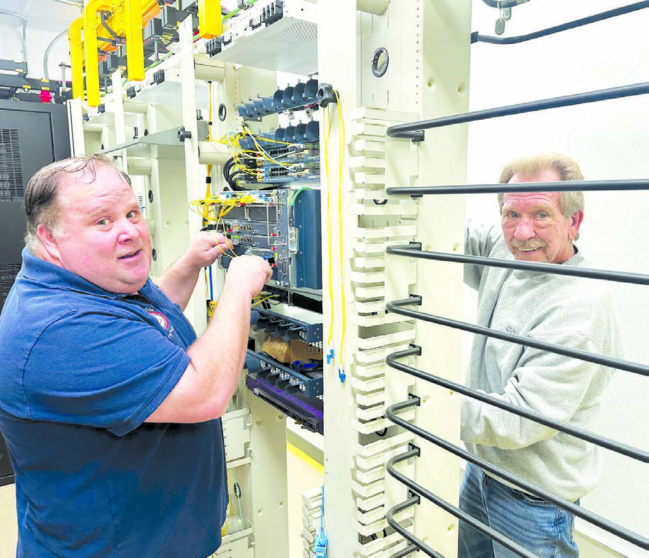 Mike Ganje, central office supervisor for the CRST Telephone Authority (left) and Larry Mroczkowski, network engineer with Calix, were at work on Monday at the facility at Timber Lake which is the “heart and brains” of the system bringing high speed internet to rural Timber Lake. Photo by Kathy Nelson