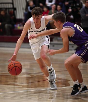 Timber Lake’s Kyler Bollinger, left, pushes the ball upcourt against a Sully Buttes defender during boys basketball action last week.