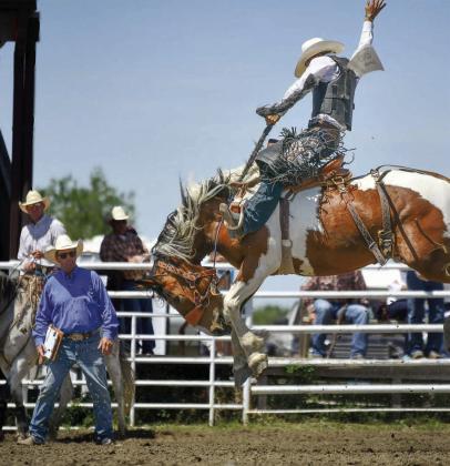 Faith cowboy Cooper Schuelke (right) punched his ticket to the State High School Finals Rodeo with a pair of winning saddle bronc rides at the Northwest Region Rodeo held last weekend in Dupree. Photo by Chuck Miner