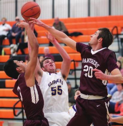 Timber Lake’s Brandt Ducheneaux (20) and Chazz Gabe (3) block the shot of a Strasburg-Zeeland player during their game at Mobridge.