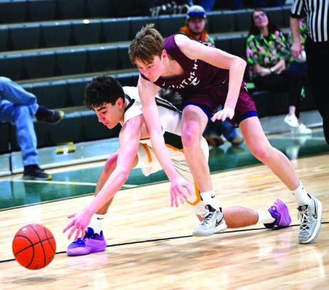 Timber Lake’s Kyler Bollinger (right) battles with an opponent for control of a loose ball during boys basketball action earlier this season. Bollinger scored a gamehigh 18 points last Tuesday in the Panthers 6149 loss to threetime defending state champion De Smet in the SoDak 16 Tournament. Photo by Marie Du Preez