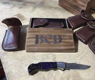 Jeremy Holien, left, is the owner of Deadeye Custom Weapons LLC in Firesteel. Above, an example of a custom knife, leather knife case and engraved wood gift box made for a customer.