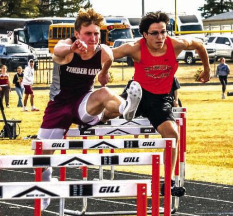 Gracen Hansen of Timber Lake nipped Simon Fried at the finish line to win the 300-meter hurdles at 41.14. With Fried running 41.22, both runners were faster than the meet record 42.49 run by Cody Cotton of Faulkton in 1998. Photo by Jay Davis/Mobridge Tribune