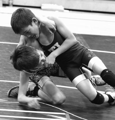 Ryder Veit (right) of the Timber Lake Youth Wrestling Club, holds Dupree’s Kemper Longbrake in a headlock while driving him to the mat during their Midgets 67 Division match at the first-ever Panther Invite Triangular featuring wrestlers from Timber Lake, Dupree and Mobridge. Veit finished third at the SDWCA District 3 regional championship last weekend and will compete at the state meet March 1517. Longbrake placed fourth in regionals, just missing the cut for state qualification. Photo by Jon Flatland