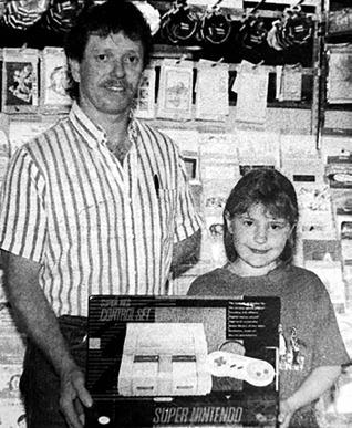 Samantha Reinbold, daughter of Robert and Jeanette Reinbold, was the winner of a Super Nintendo given away during the Kids’ Week promotion. Making the presentation is Dennis Holzer of Holzer’s Super Valu. Timber Lake Topic, June 17, 1993