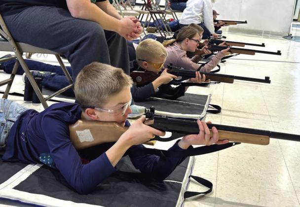 Members of the Wildcat Dead Eyes Shooting Sports Club take target practice with spotters and coaches to assist them at the Isabel Community Center. More than two dozen area youth are participating in the shooting program, which is now in its 10th year.