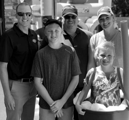 Dairy Queen owner Lonnie Heier (BACK, MIDDLE) and his family with Nathan Sanderson, executive director of the S.D. Retailers Assn. last summer.
