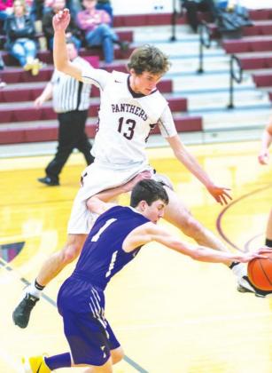 Kadoka Area’s Cole O’Bryan dribbles past a leaping Hunter Schrempp of Timber Lake during boys basketball action last Tuesday. The Panthers earned a 56-46 victory with Schrempp contributing 10 points and a handful of rebounds. Photo by Robert Slocum