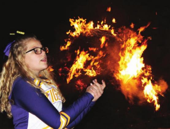 Cheerleader Trinity Leithauser leading cheers at the DHS Homecoming Bonfire that is sponsored by the DHS Booster Club.
