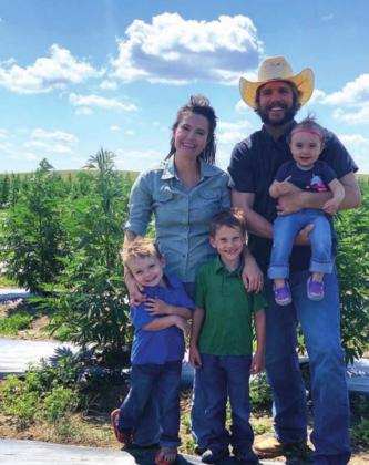 Shane and Cathy Weber and their kids (L-R) John, Reid and Allie in their hemp field last summer.