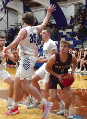 Senior guard Gracen Hansen (4) pump fakes Lemmon defender Sawyer Thompson (35) under the basket during the boys basketball season opener for both teams last Friday, Dec. 8. Timber Lake rallied late but ended up taking a 58-54 loss. Photo courtesy of Marie Du Preez