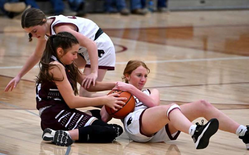 Sara Keller, right, battles with a Newell defender for a loose ball while Korbi Heck tries to assist.