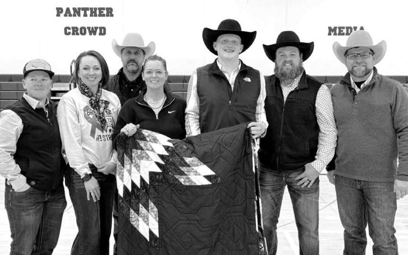 Mobridge Livestock paid $15,000 for a star quilt at the benefit for Braylen Hansen, and gifted it to Braylen. L-R are Frankie and Lyndsey Ducheneaux, J. J. and Sammy Goldade, who donated the quilt, Braylen, and Cole Mettler and Casey Perman of Mobridge Livestock.