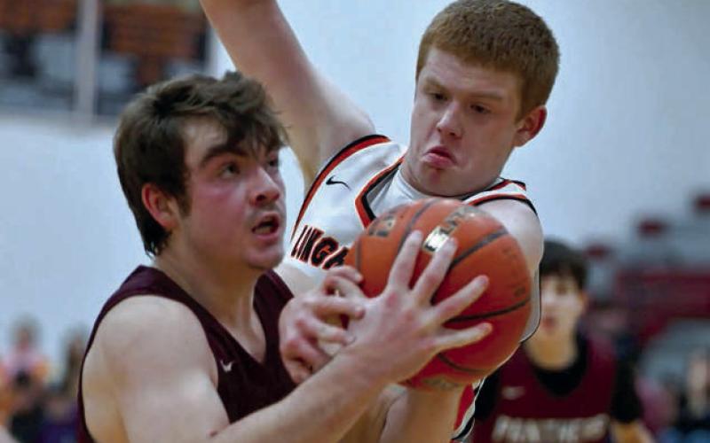 Timber Lake sophomore Treyden Beer (left) eyes the basket while being defended by Faith’s Tace Berglund on a drive into the lane during Little Moreau Conference basketball action last week. Photo by Marie DuPreez