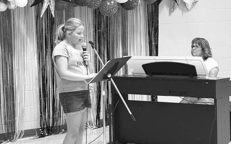 Miné Baker singing “Beauty and the Beast” at the music showcase