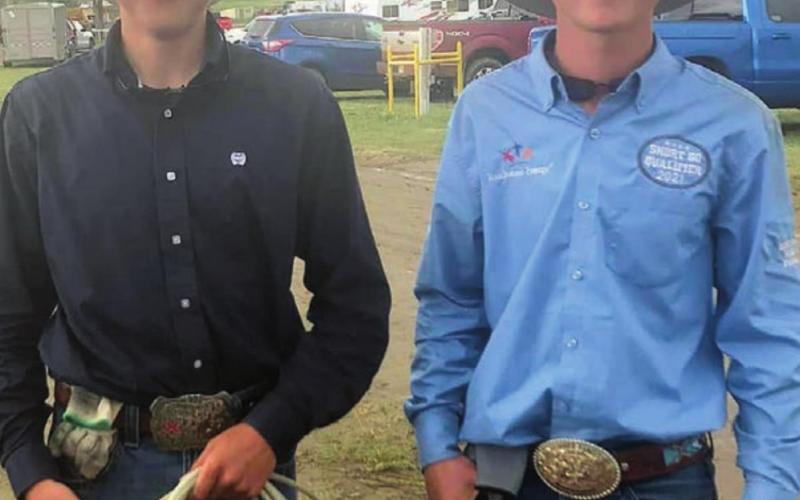 Sage Burress (L) and Rope Roghair of Isabel team roped at the region high school rodeo and also competed individually. Courtesy Photo