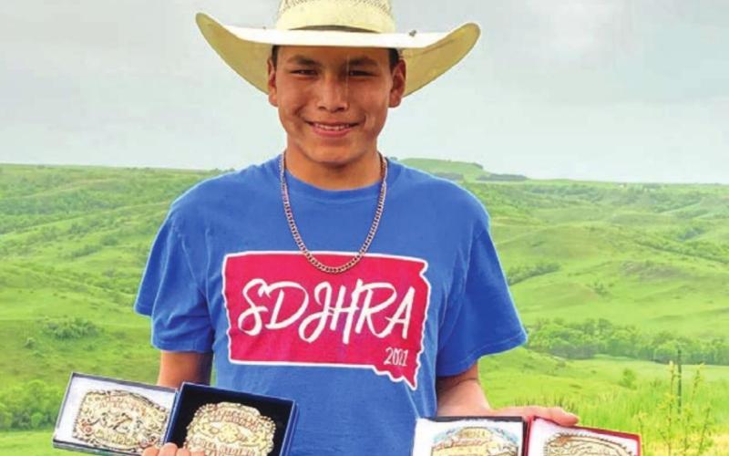 Mark Sandquist shows off some of his recently-won hardware. The 15-year-old bull and saddle bronc rider from rural Trail City won the bull riding competition at four consecutive high school and 4-H rodeos over the past two weeks. Courtesy Photo