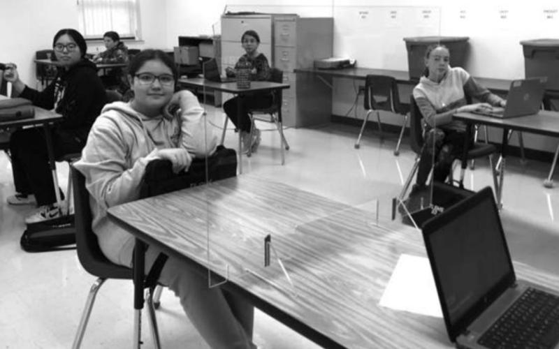 Socially distanced seating and plexiglass panels became the “new normal” for these middle schoolers this year.