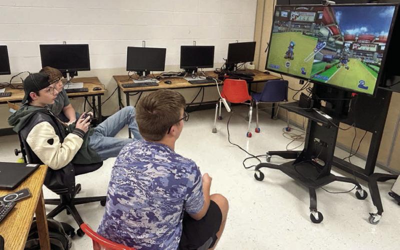 Johnny Hoyt (center) and Evan Schweitzer (right) compete in eSports league games while Nathaniel O’Bryan (far left) looks on. The Timber Lake High School eSports team is wrapping up its first season with playoffs beginning next week.