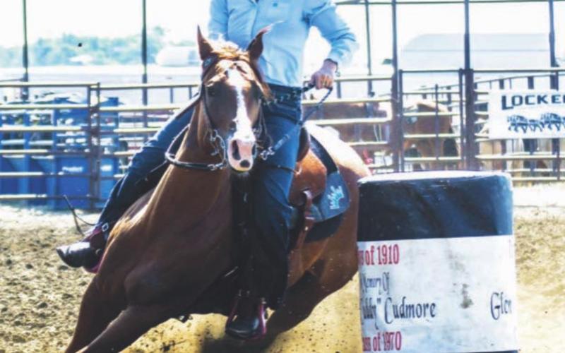 Madison Rau of Mobridge makes a turn in the barrels during Sunday’s slack at the rodeo arena. Photo by CIndy Pateneaude