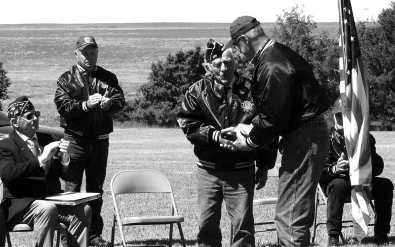 ABOVE: Herman Rosenau was one of two World War II veterans honored during the Isabel Memorial Day program. Jeff Stradinger presented him with the honor. The other World War II veteran, Robert Rose, was not able to be present.