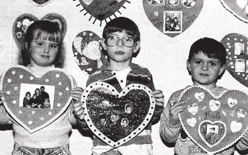 Sweethearts Timber Lake Topic, February 13, 1992 Kindergartners Jackie Kuhn, Jace Hieb, and Jason Booth show the valentines they made at home with their families. Teacher Rita Long made each student a red heart with the family’s last name on it, and the decorating was done at home. The valentines are on display in the hallway at Timber Lake Elementary School.
