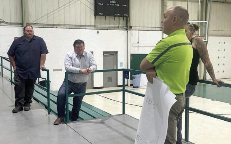 Isabel Board of Trustees members Darrel Pfaff (left) and Ryan Maher (center) discuss HVAC improvements at the Isabel Community Center with Travis Sichmeller of Sichmeller Engineering of Aberdeen. The board approved moving ahead with acquiring a complete estimate from Sichmeller for the proposed improvements. Photo by Jon Flatland