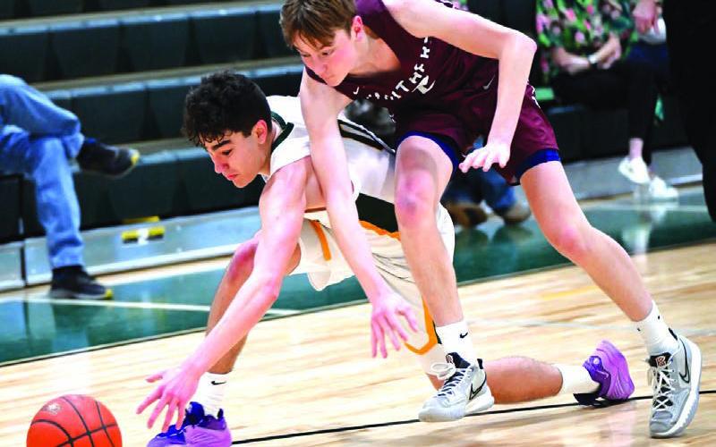 Timber Lake’s Kyler Bollinger (right) battles with an opponent for control of a loose ball during boys basketball action earlier this season. Bollinger scored a gamehigh 18 points last Tuesday in the Panthers 6149 loss to threetime defending state champion De Smet in the SoDak 16 Tournament. Photo by Marie Du Preez