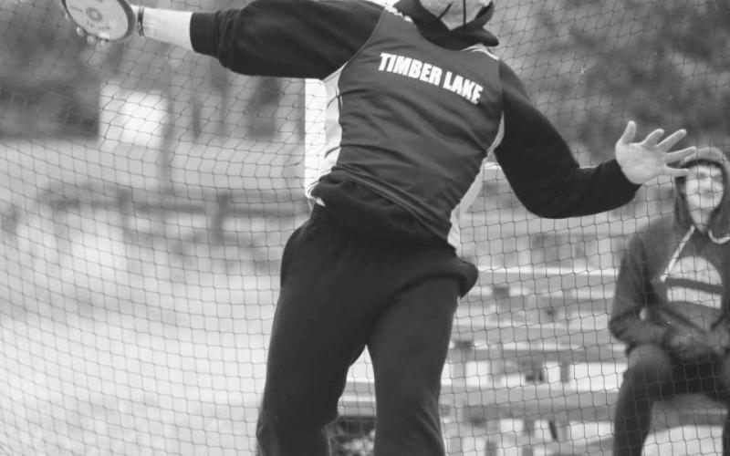 Timber Lake senior AJ Lindskov throws the discus while competing at the Timber Lake Track Invitational at Doug Kraft Field last Tuesday, April 25. Athletes battled cold, gusting winds from the north that put temperatures on the track just above 30 degrees. Lindskov overcame the cold to finish second in the discus with a mark of 105-9 feet.