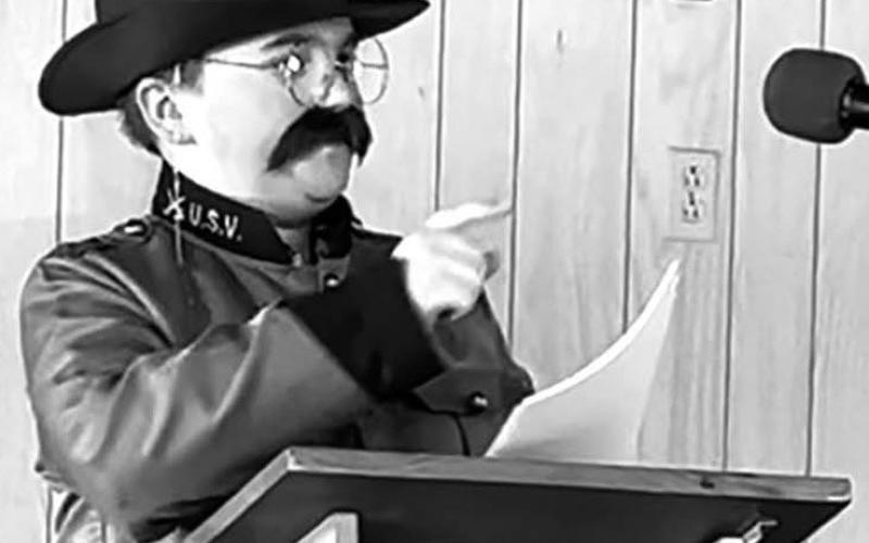 Caleb Simon at the CC end of year celebration performing his “Faces of History” Capstone project on Theodore Roosevelt.
