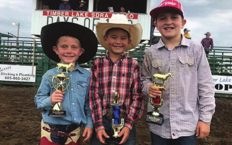 Mutton bustin’ winners at the latest ranch rodeo in Timber Lake on Saturday were L-R Vern Long, Ryder Veit and Luke Biegler. Photo by Jon Flatland