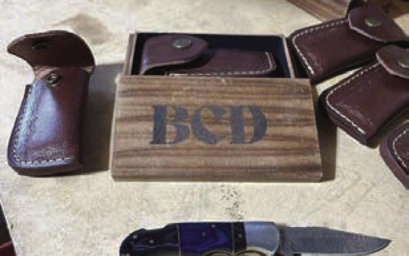 Jeremy Holien, left, is the owner of Deadeye Custom Weapons LLC in Firesteel. Above, an example of a custom knife, leather knife case and engraved wood gift box made for a customer.