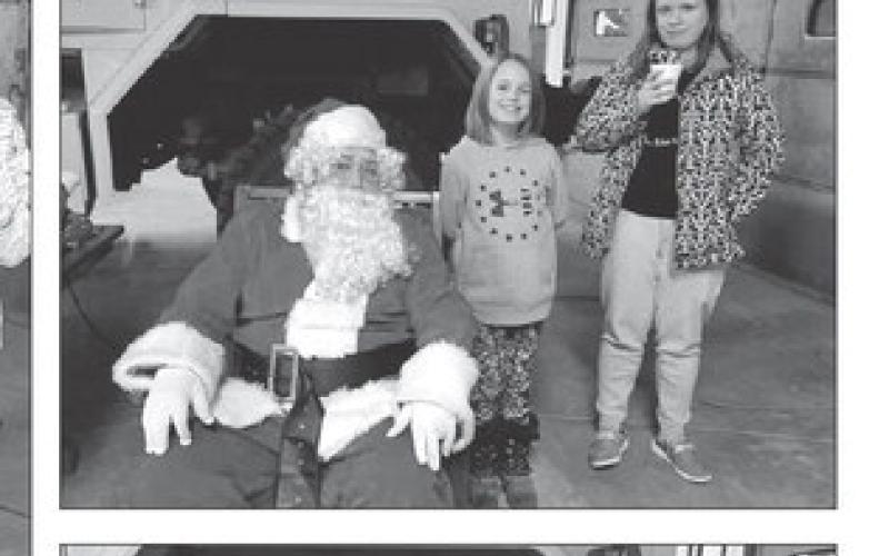 Kids have pictures, hot chocolate with Santa at Isabel