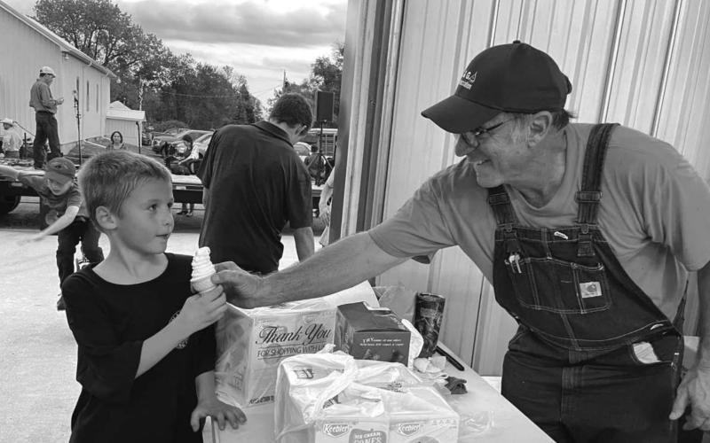 ABOVE: Max Biegler gets a free ice cream cone from Kelly Landis.