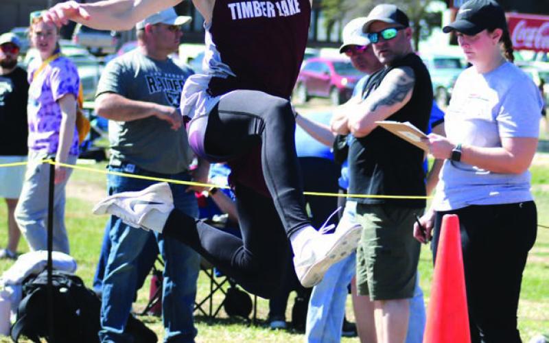 TJ Alley eyes his landing during triple jump competition at a recent outing in Mobridge. Timber Lake was slated to compete at the Ipswich Invitational on Saturday but it was cancelled due to high winds and low temperatures. Photo by Jon Flatland