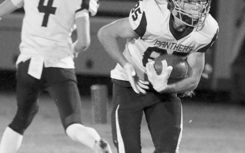 Junior running back Carter Keller looks for running room during Timber Lake’s matchup against Faith last Friday, Sept. 23. Keller picked up 22 yards on six rushing attempts. Photo by Jon Flatland