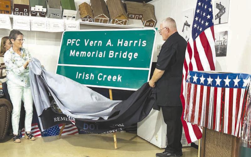 The Fallen Heroes Memorial Bridge sign is unveiled by Mary Harris and Jim Harris at Isabel on Sunday.