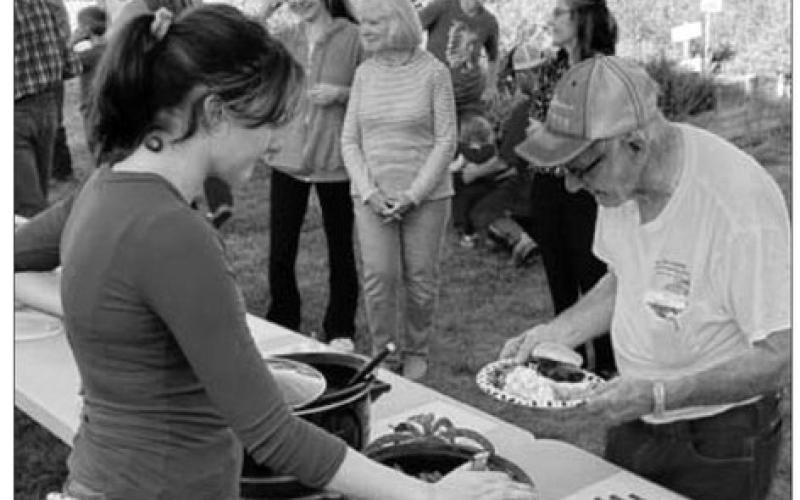 Norman Hieb (RIGHT) was invited to start the line at the meal served at the Timber Lake School Healing Hands (Owaste Napiceya) Garden on September 19. Lola Hornick (LEFT) was one of the servers. Dishes prepared from the garden’s produce were served, along with burgers from beef donated by Lindskov LT Ranch, Schrempp Cattle Co., Maher Ranch, and Hornick Ranch.
