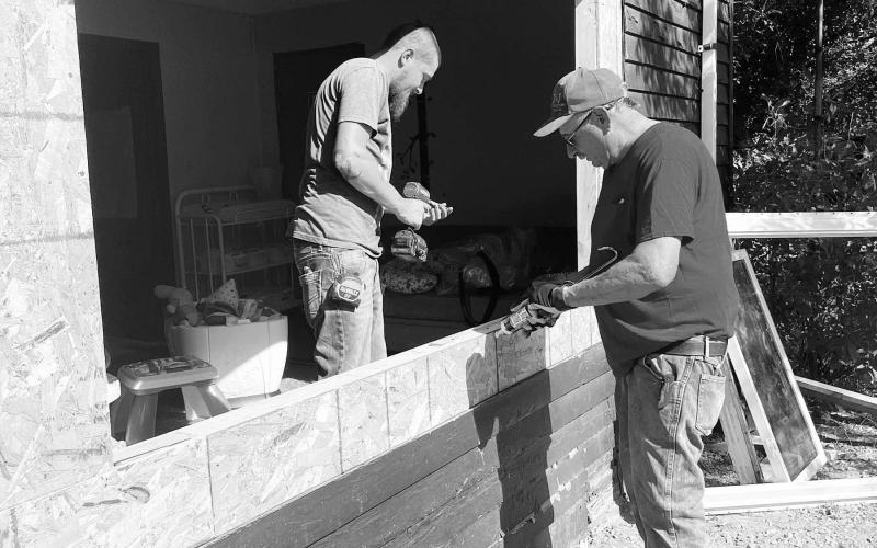 Joel Mattern (RIGHT), owner of J&amp;amp;J Construction of Lemmon and a member of the McIntosh Class of 1972, and one of his employees, Joey Heidecker, install new windows in the McIntosh Daycare.
