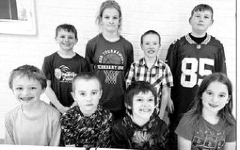 AT RIGHT: 3rd and 4th grade FRONT (L-R): Third graders Ben Mareska and Camden Goldade (winners) and Colton Ridl and Baicyn Lei (alternates). BACK: Fourth graders Barrett Maciejewski and Brynn Lemburg (winners) and Greyson Goldade and Brayden Meier (alternates).