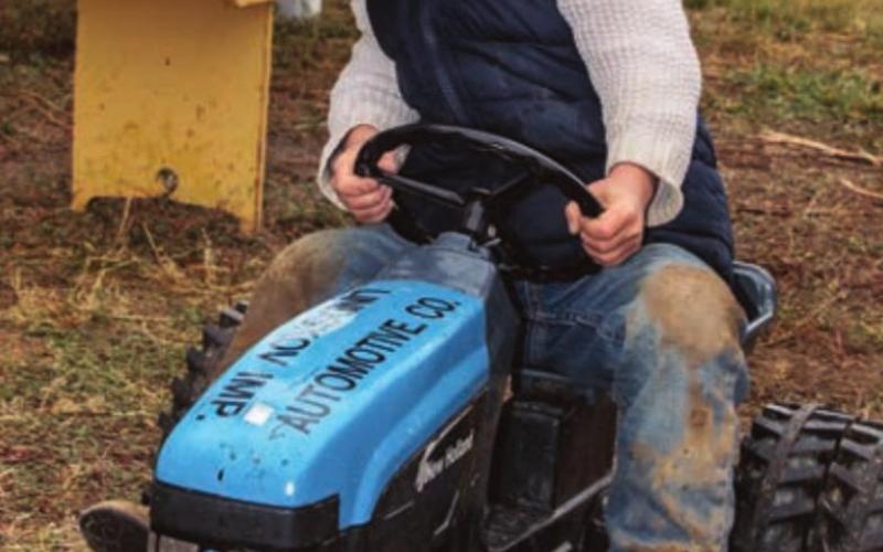Young ranch hand Bryer Wakeley, son of Sierra and Schyne Wakeley of rural Bison, gets warmed up for the kid’s pedal tractor pull Saturday afternoon.