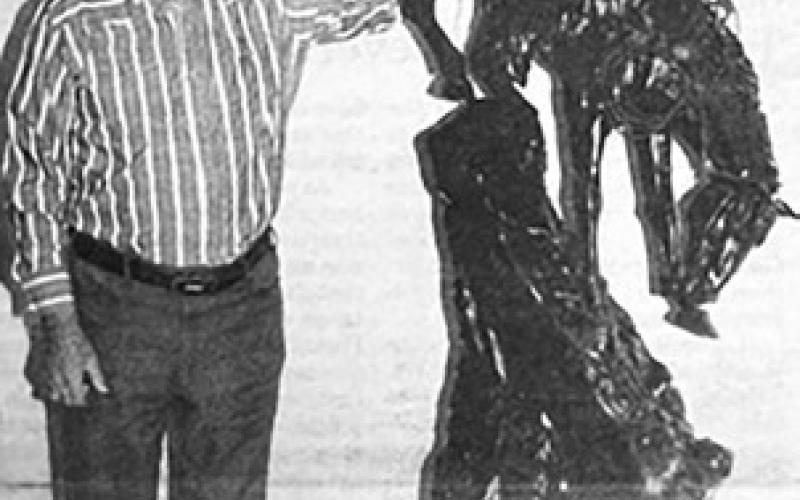 Col. Maynard Booth with the Frederic Remington sculpture he donated to the Timber Lake Museum