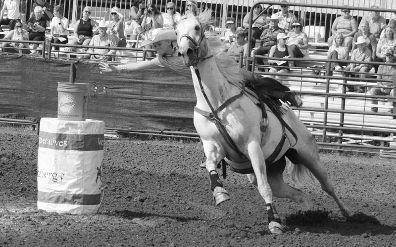 Gwen Gebhart of Meadow stretches in an attempt to reach the flag during the flag race event at the South Dakota State 4-H Finals Rodeo held Aug. 16-18 in Ft. Pierre. Photo by Jon Flatland