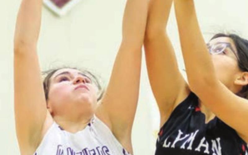Timber Lake’s Abby Linderman (21) tries to grab the ball away from Lyman’s Keslyn Wells (15).