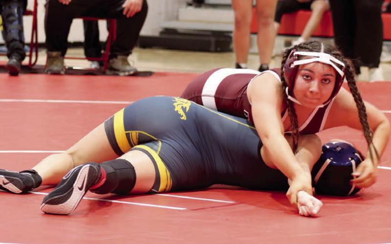 Selena Longbrake (top) bears down while pinning her opponent, Ashley Ghost of Little Wound, in the first round of the C-EB/Dupree Round Robin Wrestling Invitational in Eagle Butte on Monday, Feb. 3. Longbrake, wrestling at 126 pounds, went 3-0 during the event to help the Lady Panthers win second place overall in the team standings. Photo by Jon Flatland
