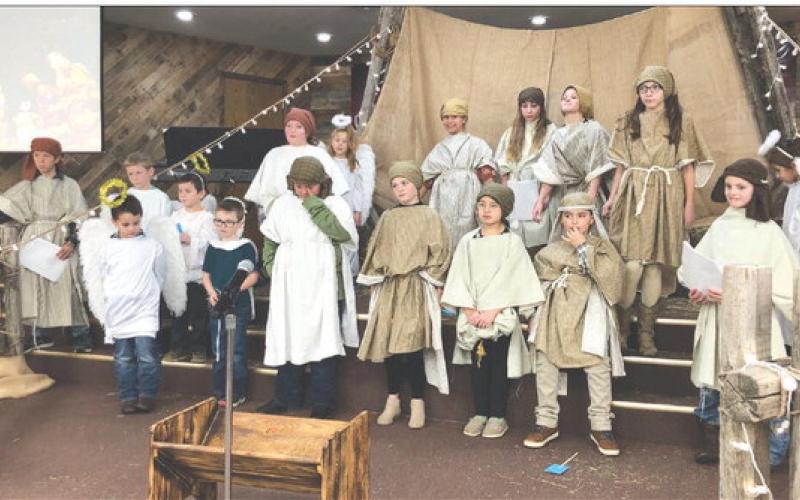 The children of New Hope Church at Timber Lake presented a Christmas program during the worship service on Sunday, December 11. Participants were FRONT (L-R): D.W. Schultz, Waylon Maher, Ridge Means-Takes The Knife, Alexa Roggow, Leah Eigelaar, Luhan Fourie, Louis Scholtz; BACK: Max Goldade, T.K. Paxton, Tash Paxton, Ronnilyn Long, Dolly Goldade, Naomi Goldade, CeCe Cowan, Brynn Lemburg, Bricelyn Pederson, Nika Fourie. Photo by Pastor Bryce Schaffer