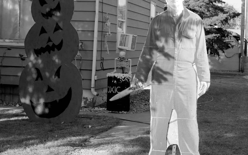 There’s not a crazy man with a knife loose in Timber Lake ... that’s just a cardboard cutout of Jason from the Halloween horror movie series hanging out in the front yard of Bruce Schweitzer along with some scary pumpkins, a toxic waste barrel and more. Photo by Jon Flatland