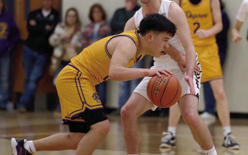 Dupreee guard Tre White Wolf attempts to dribble around the defense of Timber Lake’s Cole Ducheneaux during their meeting in the Region 8B quarterfinals last Thursday, March 6. Timber Lake pulled out a 56-53 win before a standing-room-only crowd to advance to the So Dak 16. The Panthers were playing Wessington Springs in Ft. Pierre as this issue of the Topic went to press. Photo by Marie DuPreez