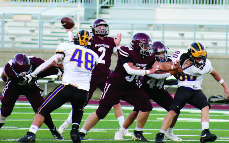 Timber Lake quarterback Cole Ducheneaux (2) fires a pass from the pocket behind pass protection from linemen Rylan Keller (55), Mason Bickel (54) and Chris Peterson-Lemmon (44) during the Panthers’ 3814 win over the Wolverines last Friday at Northern State University’s Dacotah Bank Stadium in Aberdeen. Ducheneaux threw for a season-high 225 yards and three touchdowns and was only sacked once as Timber Lake improved to 3-2 on the season. Photo by Jon Flatland